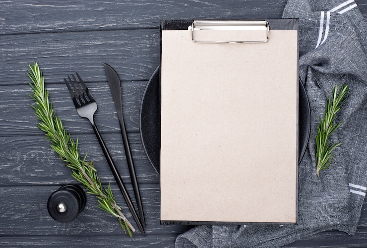 Free Photo clipboard on table with plate and cutlery