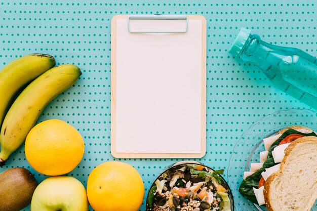 Clipboard with bottle and healthy food