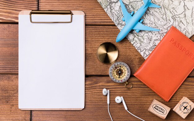 Clipboard with compass and passport on the table