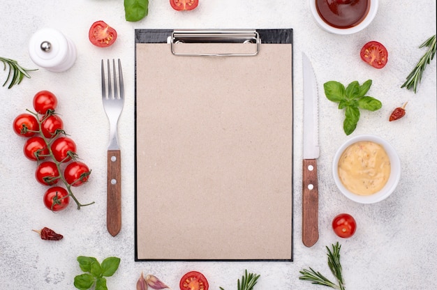 Free photo clipboard with cutlery and ingredients