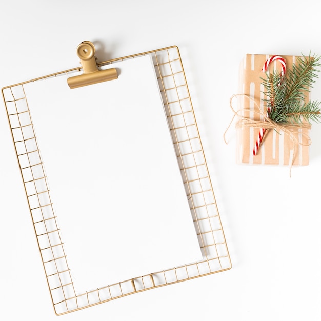 Free photo clipboard with gift box on white table