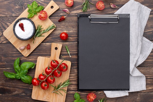 Clipboard with ingredients on table