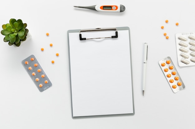 Clipboard with pills beside