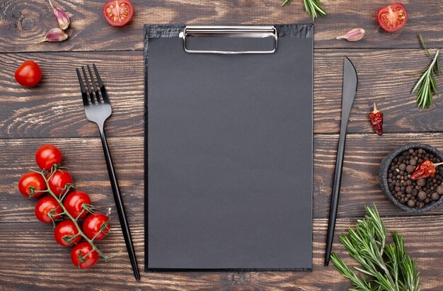 Clipboard with tomatoes and cutlery