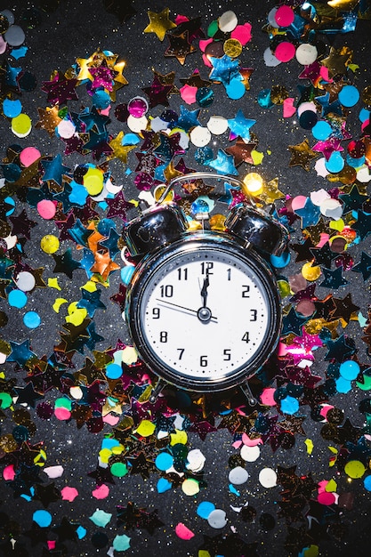 Free photo clock before midnight on festive floor