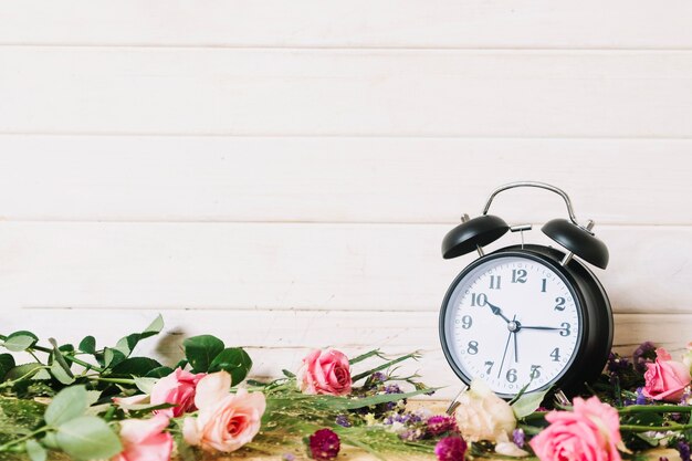 Clock and blooming flowers assortment