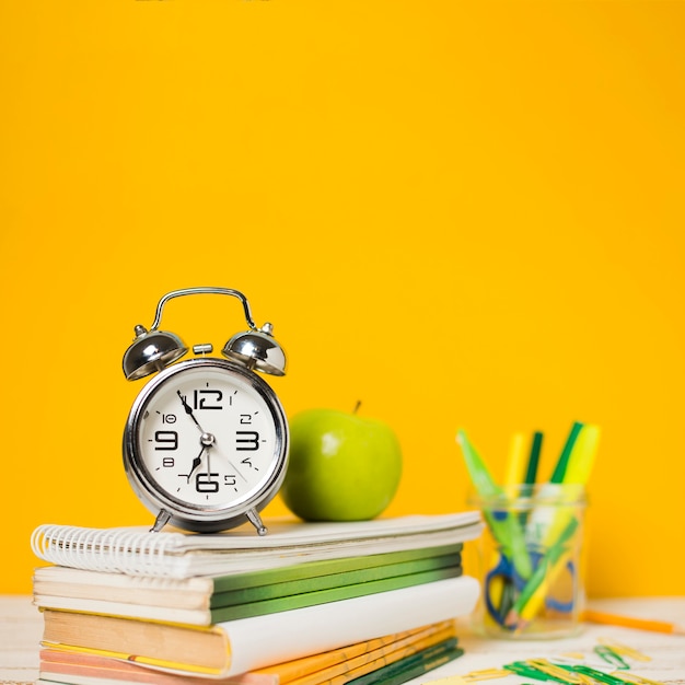 Clock and books with defocused background 