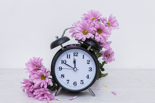 Clock and purple flowers