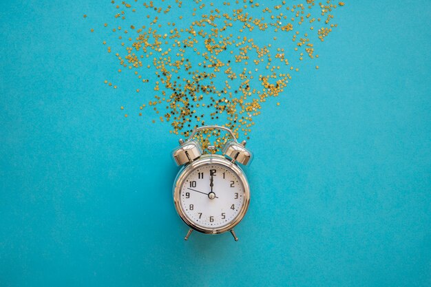 Clock with bright spangles on table