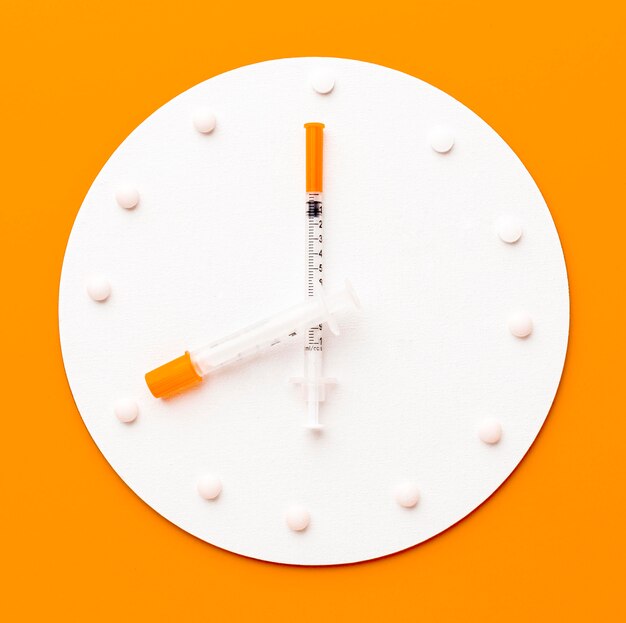 Clock with pills and syringe