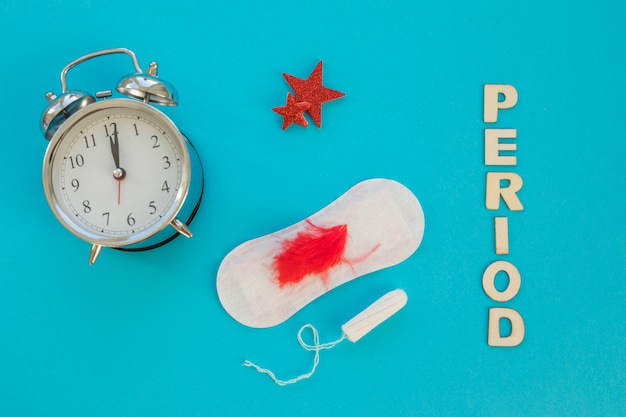 Clock with sanitary towel and tampon