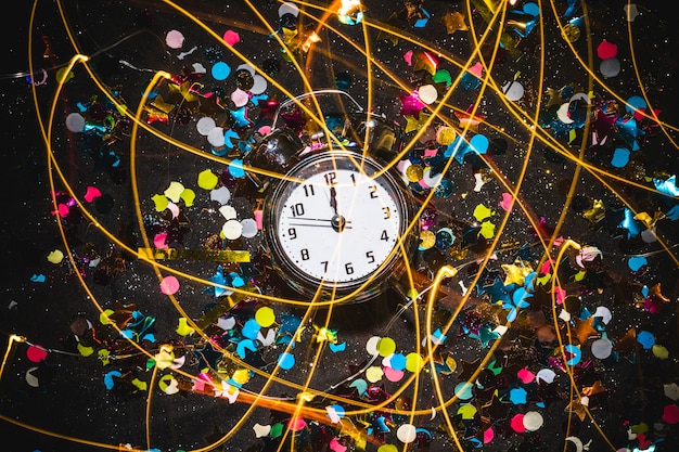 Clock with spangles on black table