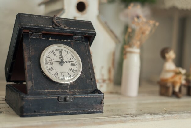 clock on a wooden background.