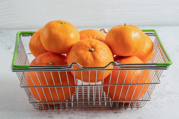 Cloe up photo of fresh organic mandarins in basket. 