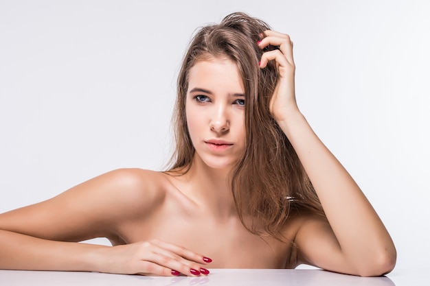 Close portrait of sexy brunette model girl without clothes with fashion hairdo isolated on white background