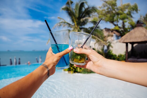 Close shot of hands hold alcohol cocktails