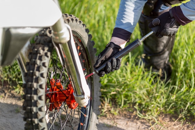 Close-up active rider checking wheel pressure