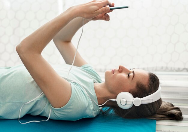 Close-up active woman listening to music