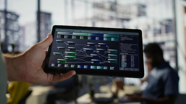 close up of admin in office sing tablet to design machine learning algorithms