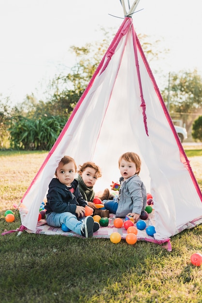 Close-up of adorable children playing in tepee
