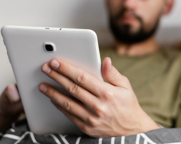 Close-up adult holding tablet