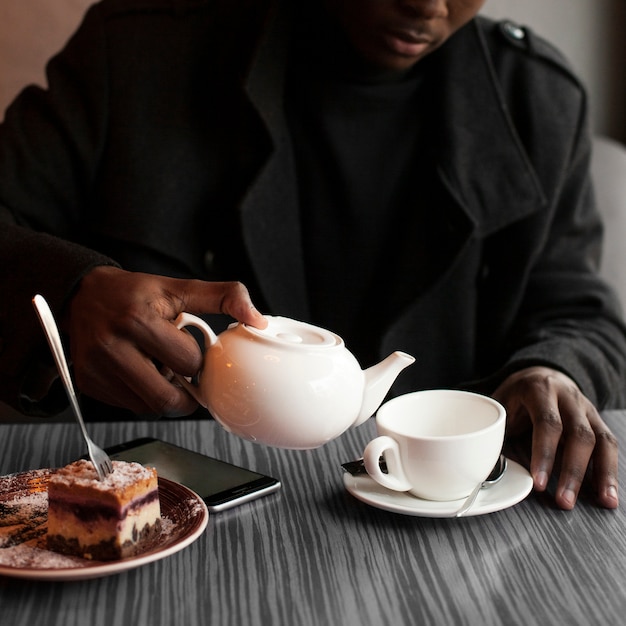 Close-up adult male enjoying a cup of tea