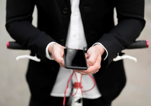 Close-up adult male holding mobile phone