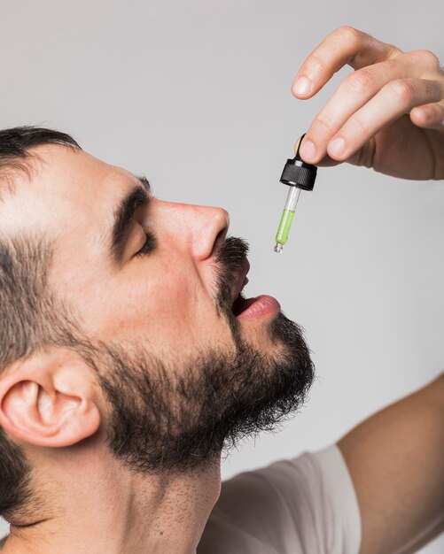close-up adult male swallowing drops