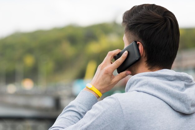 Close-up adult man talking on the phone