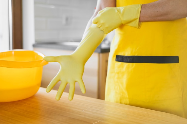 Close-up adult putting on gloves