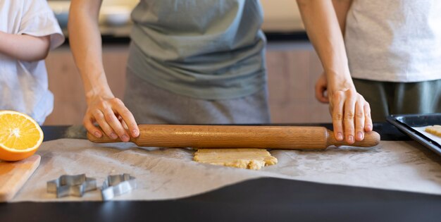 Close-up adult spreading dough