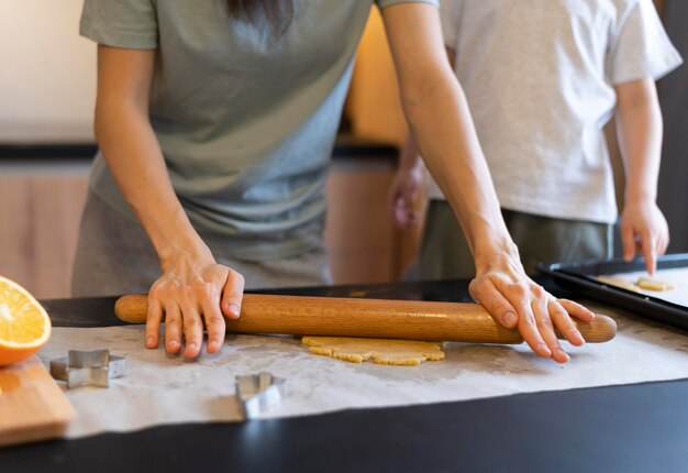 Close-up adult using rolling pin