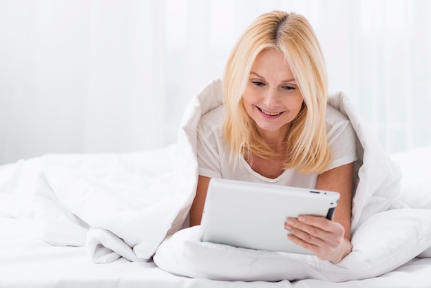 Close-up adult woman browsing a tablet