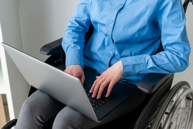 Close-up adult woman holding a laptop