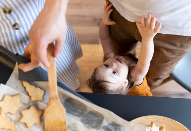 Close-up adults and kid in kitchen