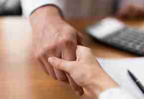 Free photo close-up adults shaking hands at the office