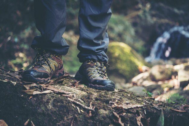 Close up of adventure man feet walk on a mountain path.