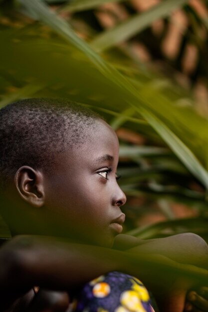 Close-up african kid posing with leaves