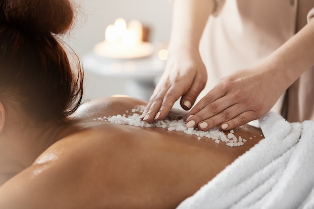 Free photo close up of african woman relaxing enjoying spa health massage with sea salt.