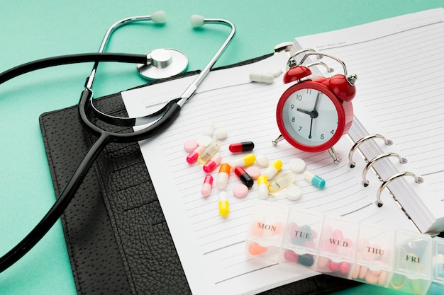 Close-up agenda and pills on desk