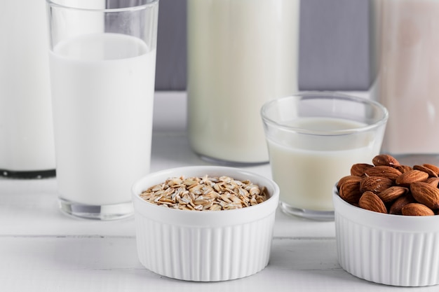 Close up almonds and oatmeal with milk glasses