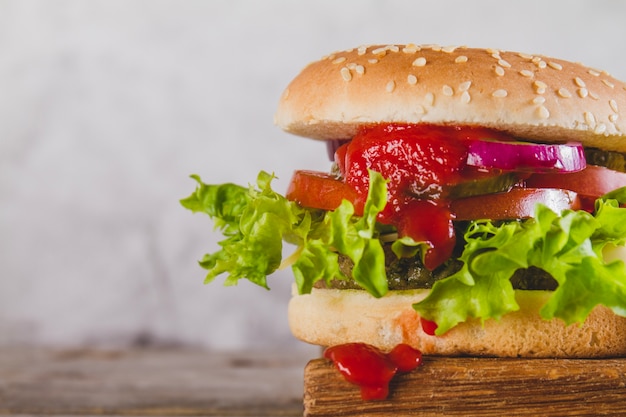 Close-up of appetizing burger with lettuce and tomato