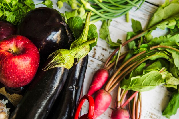 close-up of a apple; eggplants and radishes