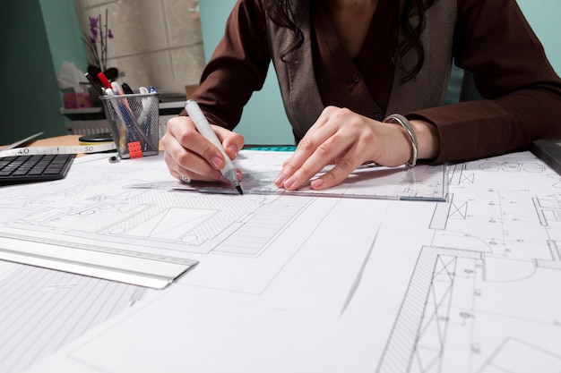 Close up of architect hands working on blueprints. business and creativity. architecture job