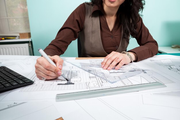 Close up of architect woman at her working desk. Working on new projects. Architecture and design