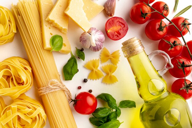 Close up arrangement of uncooked pasta and ingredients