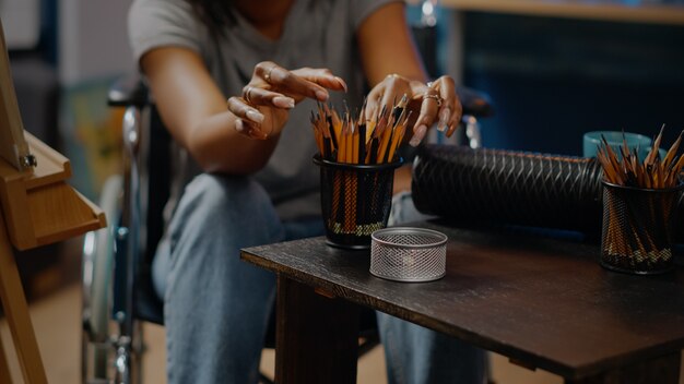 Close up of art tools and pencils on table in artwork space