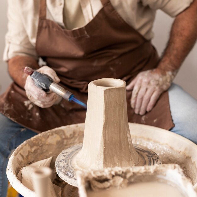 Close up artisan holding tool