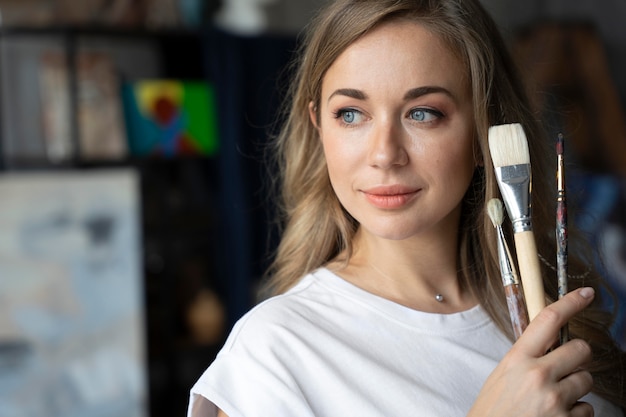 Close up artist holding brushes