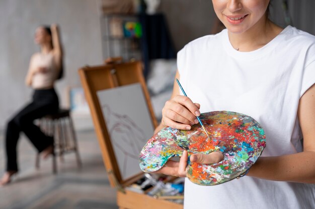 Close up artist holding paint palette